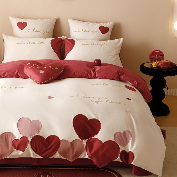 Romantic bedding set made of cotton satin with appliquéd hearts and golden embroidery