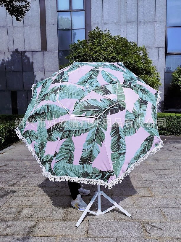 Ladies sun umbrella with tropical leaf design and tassel decoration Stornfield
