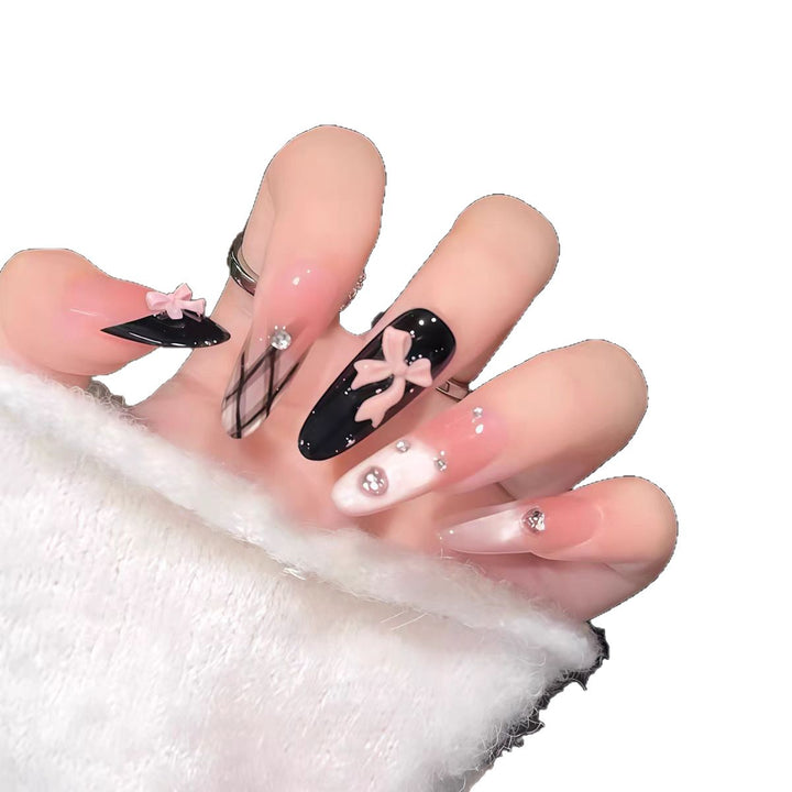 Artificial nails with playful bow and glitter accents Stornfield