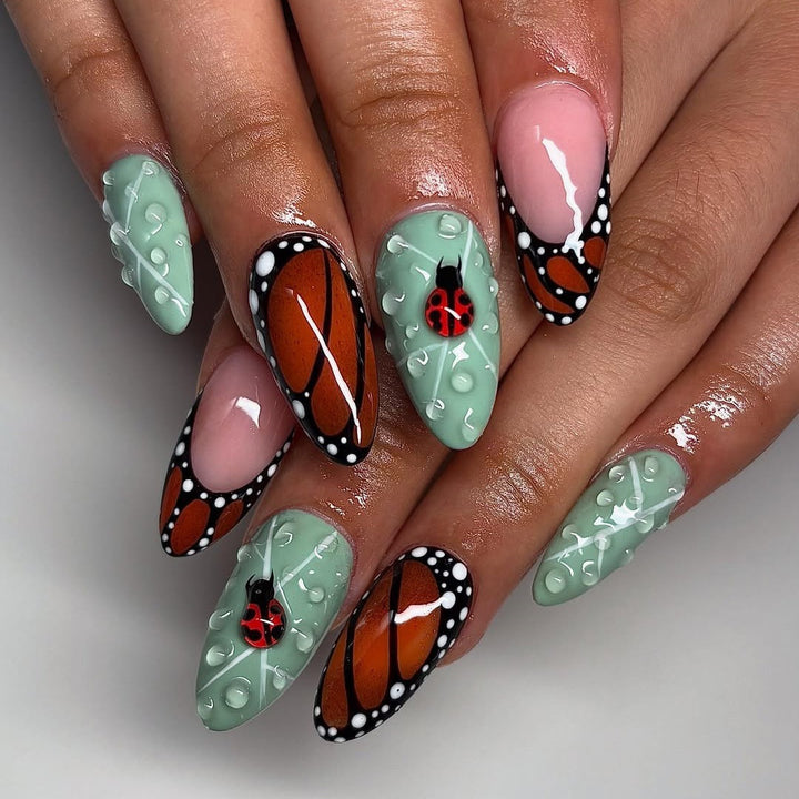 Creative nail art with elaborate butterfly and flower designs Stornfield