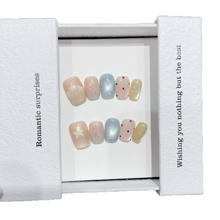 Artificial nails with romantic designs and sparkling accents Stornfield