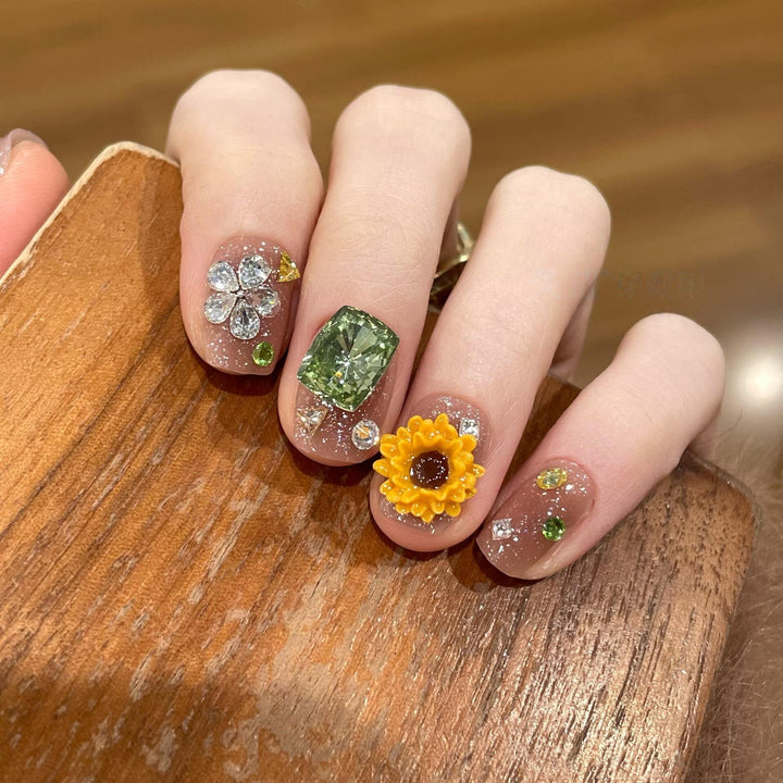 Artificial nails with sparkling appliqués and floral designs Stornfield