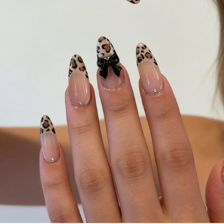 Artificial nail tips with elegant leopard pattern and bow decoration Stornfield
