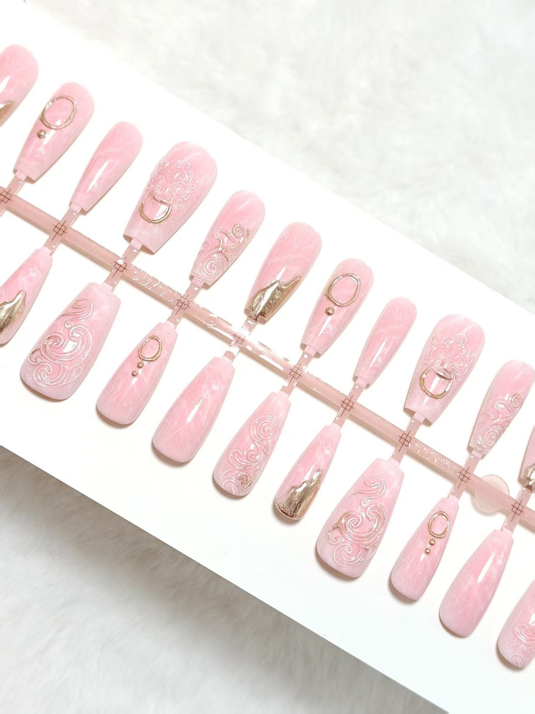 Artificial nails with elegant gold embellishments Stornfield