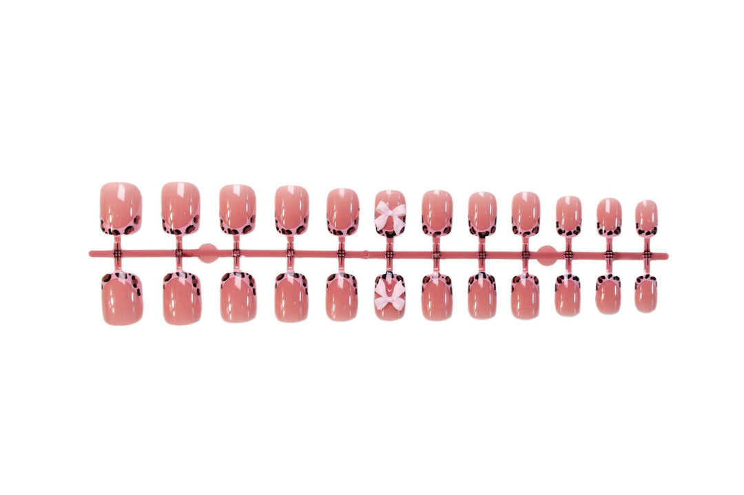Nail set with playful bow design and lively animal accent Stornfield