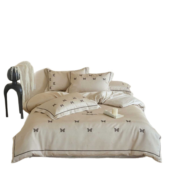 Cotton satin bed linen set with fine butterfly embroidery and piping detail