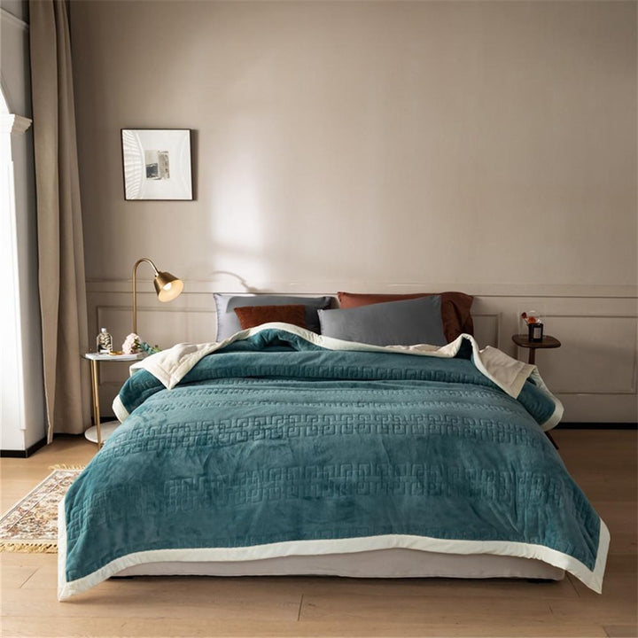 Reversible quilted comforter with structured box stitching and cotton trim