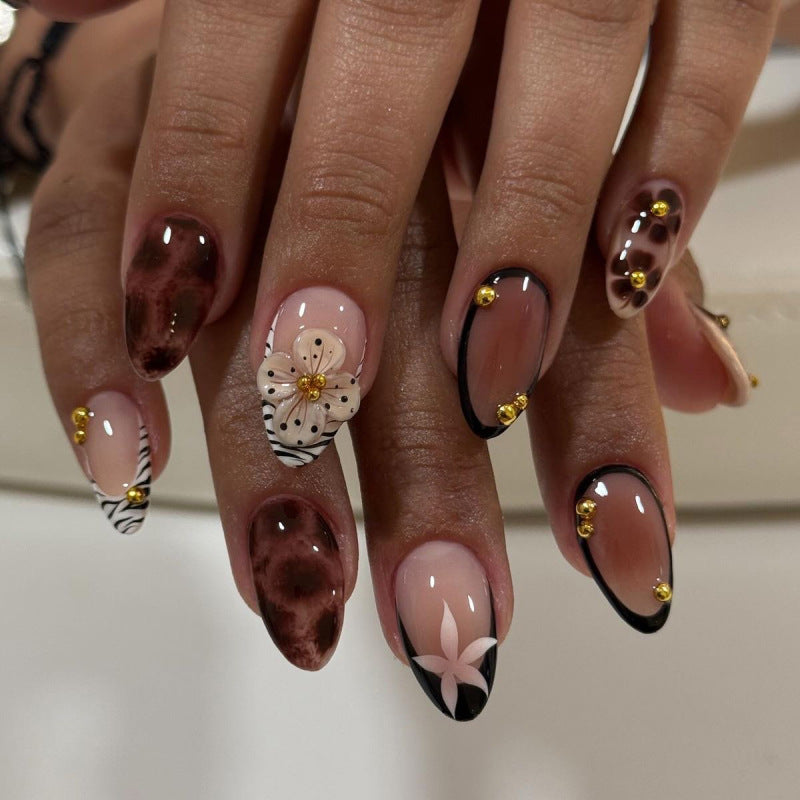 Nail Art with elegant flower design and glitter accents Stornfield