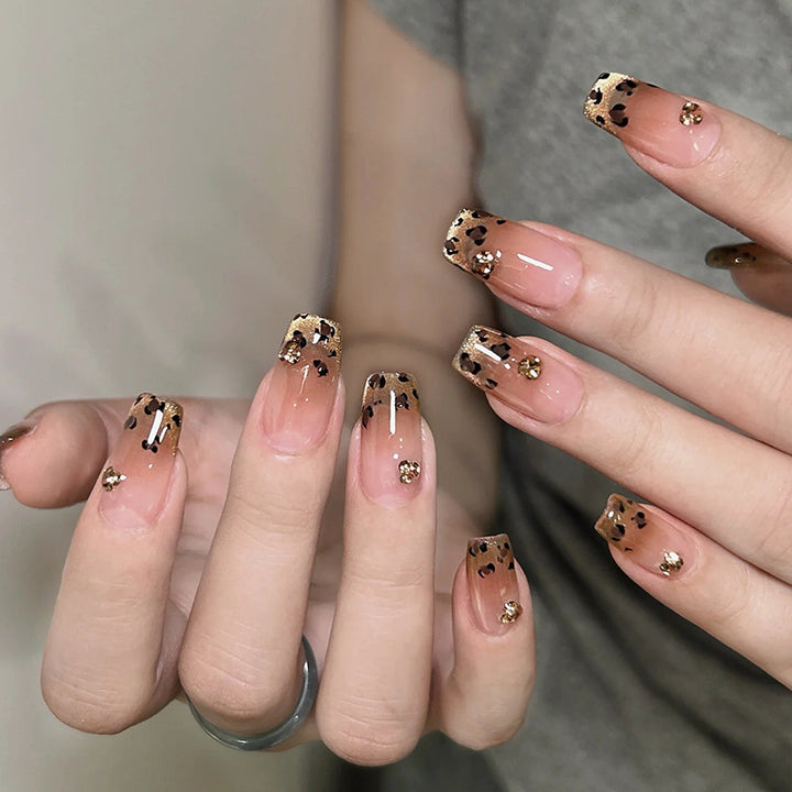 Artificial nails with shimmering leopard design and elegant accents Stornfield