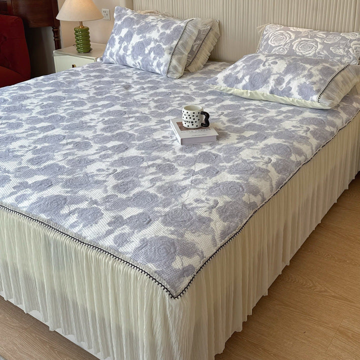 Quilted mattress and pillow set with butterfly motif and pleated bed ruffle