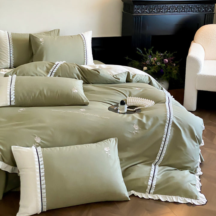 Cotton satin bed linen set with delicate rose embroidery, ruffled edge and contrasting reversible look