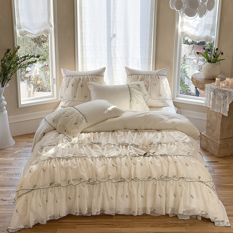 Vintage-inspired ruffle bed set with fine floral embroidery and ruched coverlet