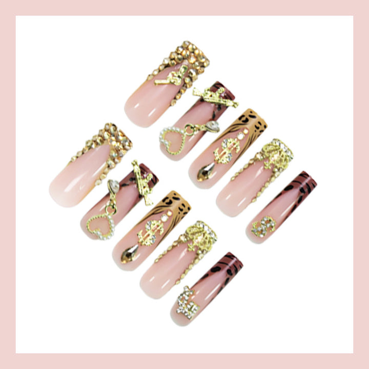 Artificial nail set with elegant golden and animal decorations Stornfield