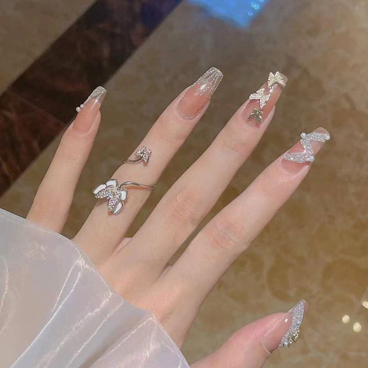 Artificial nails with sparkling rhinestone and bow accents Stornfield