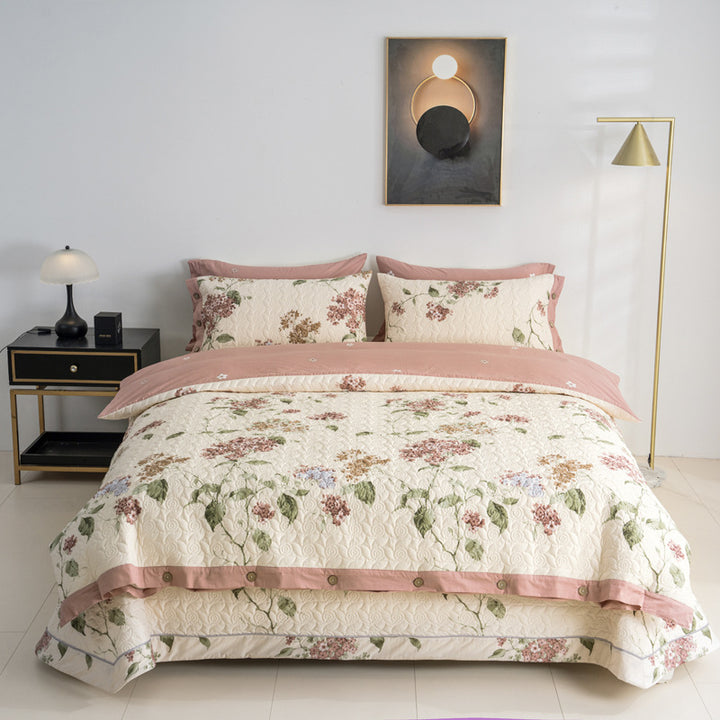 Quilted bedspread and bedding set with floral print, reversible function and decorative button placket