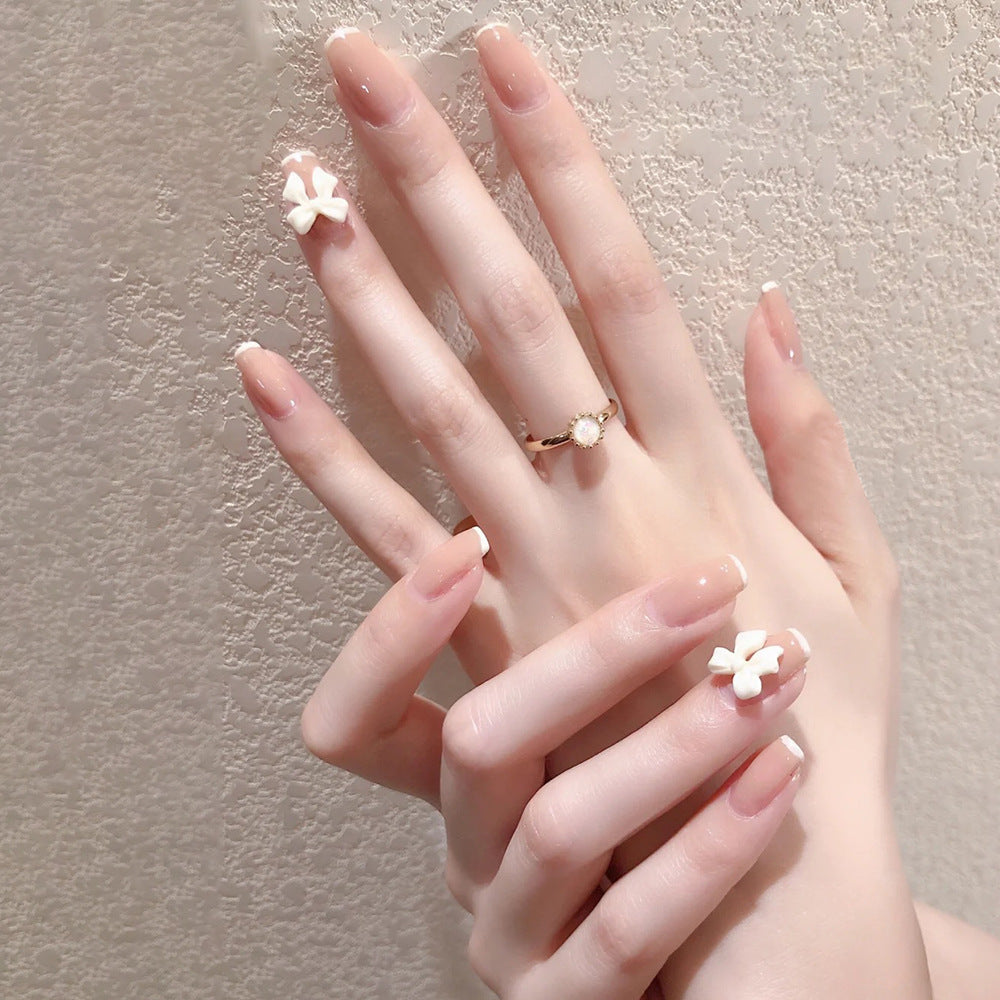 Glamorous artificial nails with heart design and glittering accents Stornfield