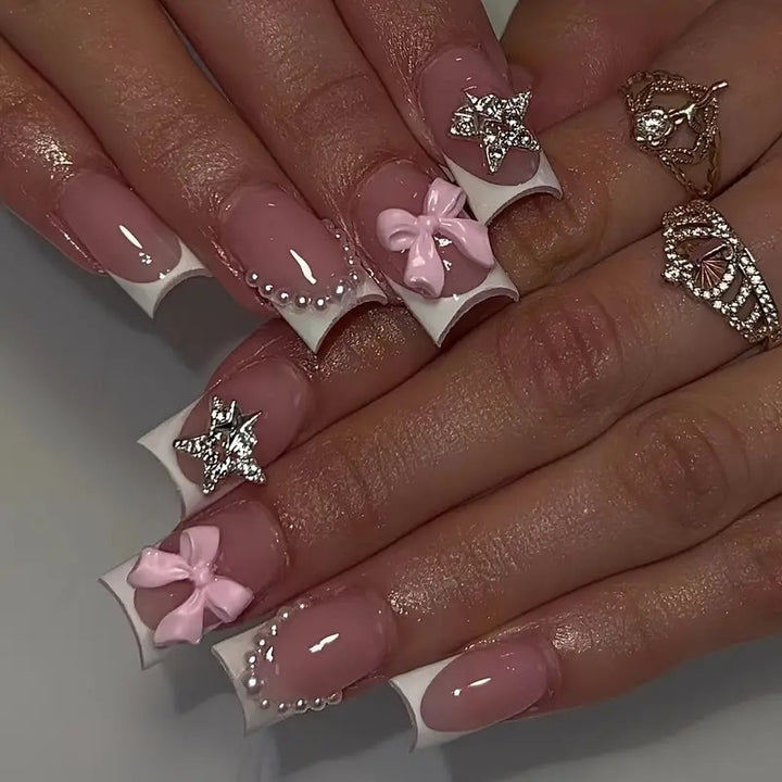 Artificial nail tips with glamorous bow and rhinestone design Stornfield