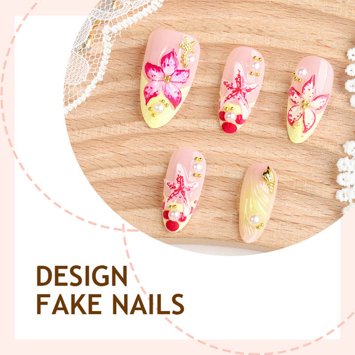 Artificial nail set with delicate floral decorations and glitter accents Stornfield