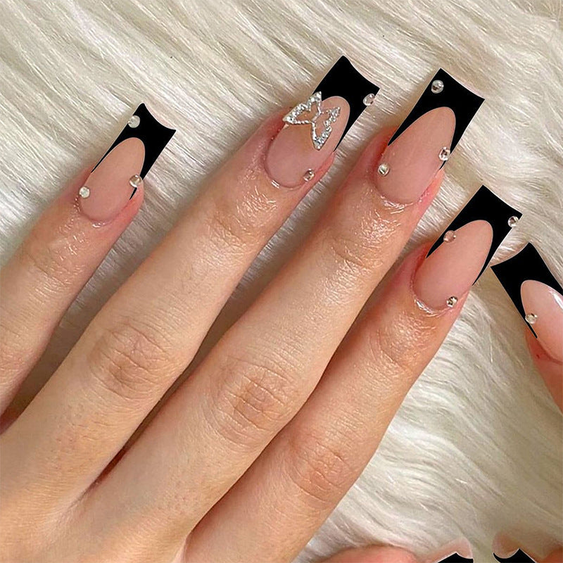 Acrylic nail set with elegant black and white design and glitter accents Stornfield