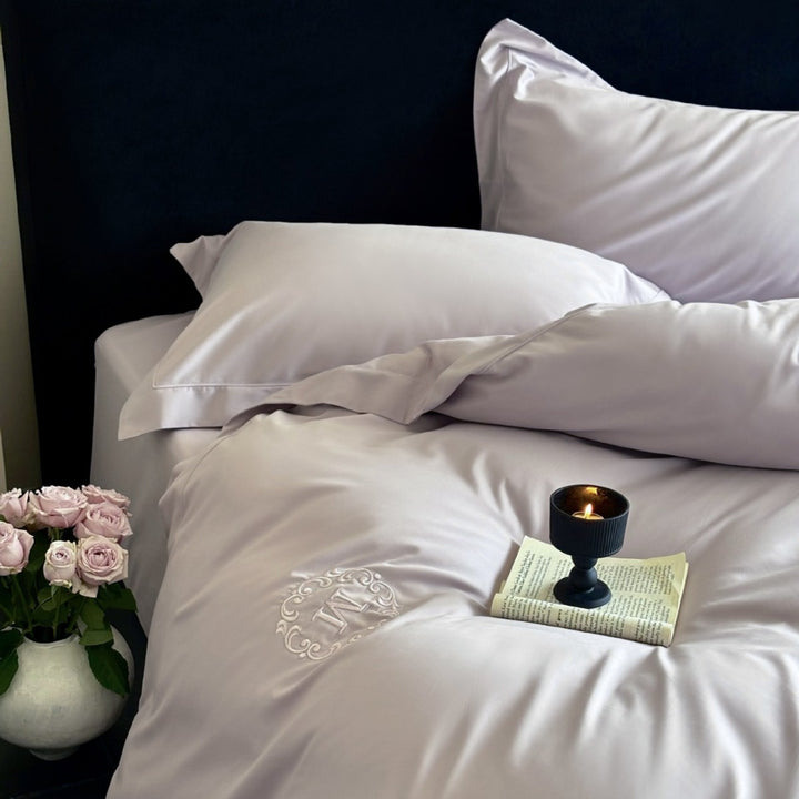 Luxurious cotton satin bedding set with monogram embroidery and fine piping