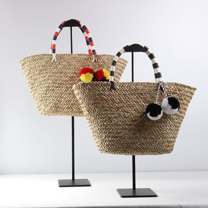 Braided beach bag with decorative pompons Stornfield