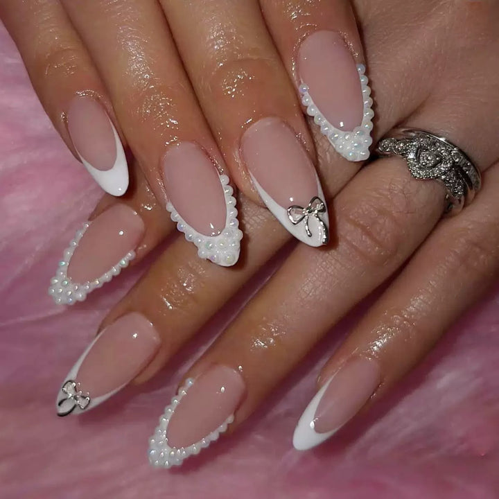 Acrylic nail set with elegant pearl and bow decorations Stornfield