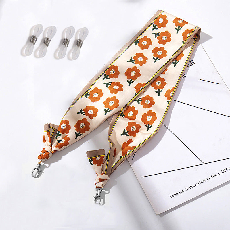 Fashionable fabric mask holder with floral motifs Stornfield