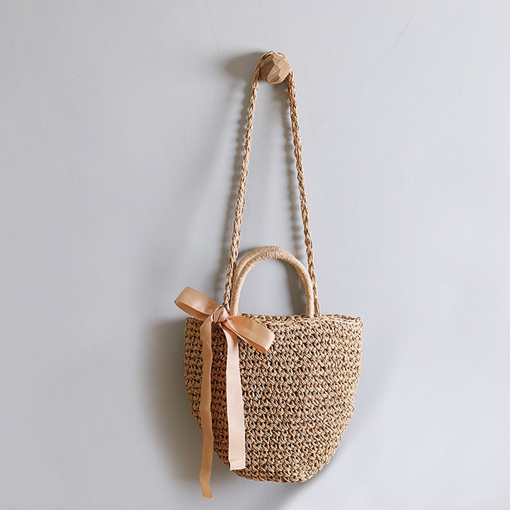 Basket bag with stylish carrying handles and decorative bow Stornfield