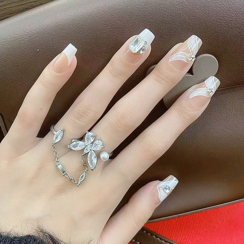 Elegant artificial nail set with delicate decorations and glitter elements Stornfield