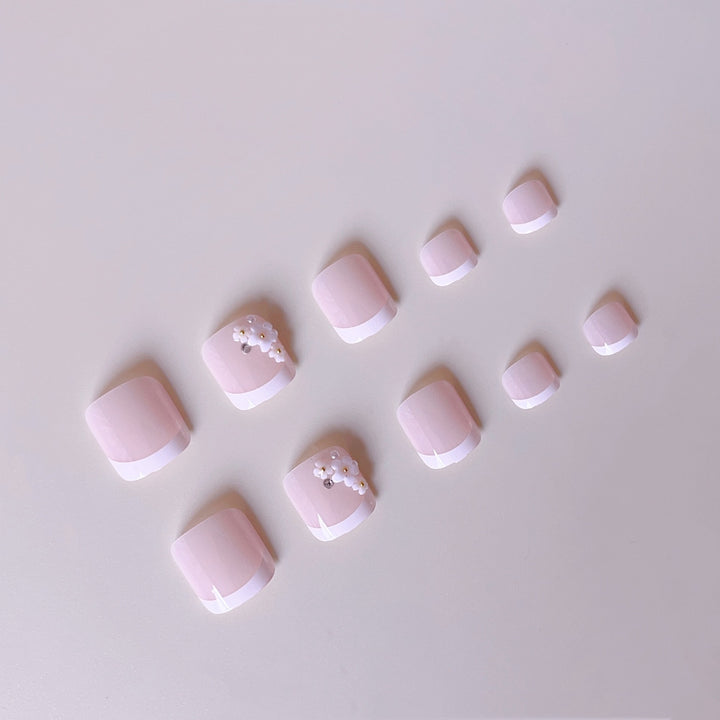 Elegant toenail art with delicate 3D floral decorations Stornfield