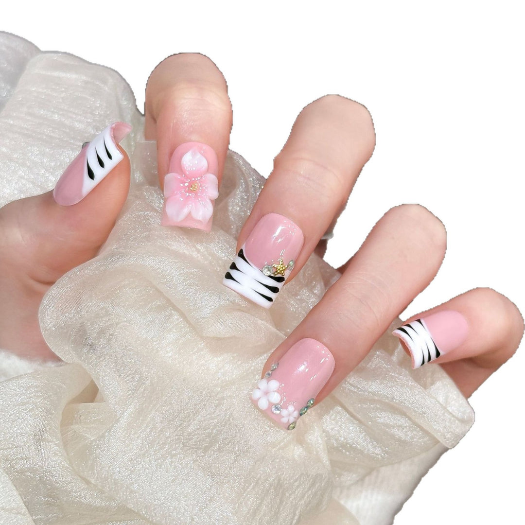 Artistic Press-On Nail Enhancements with Pattern and Gem Accents