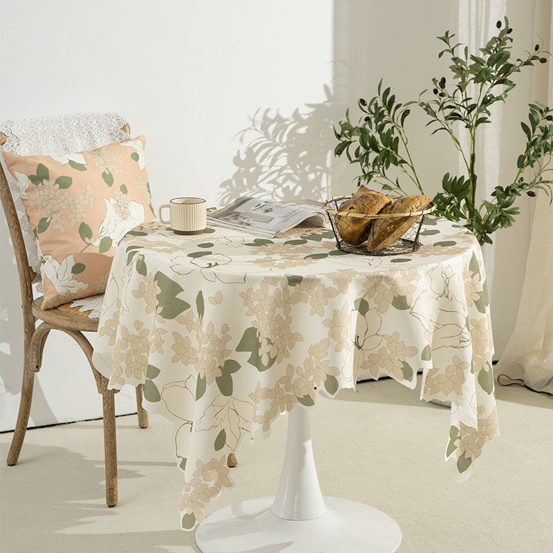 Round wipeable tablecloth with floral cut-out hem Stornfield
