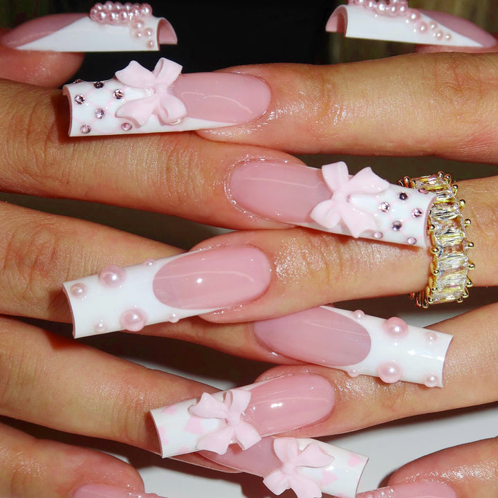 Artistic acrylic nails with bow and pearl decorations Stornfield