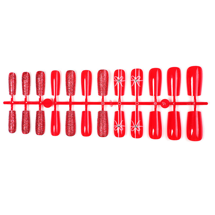 Creative acrylic nail set with glitter and bow designs Stornfield