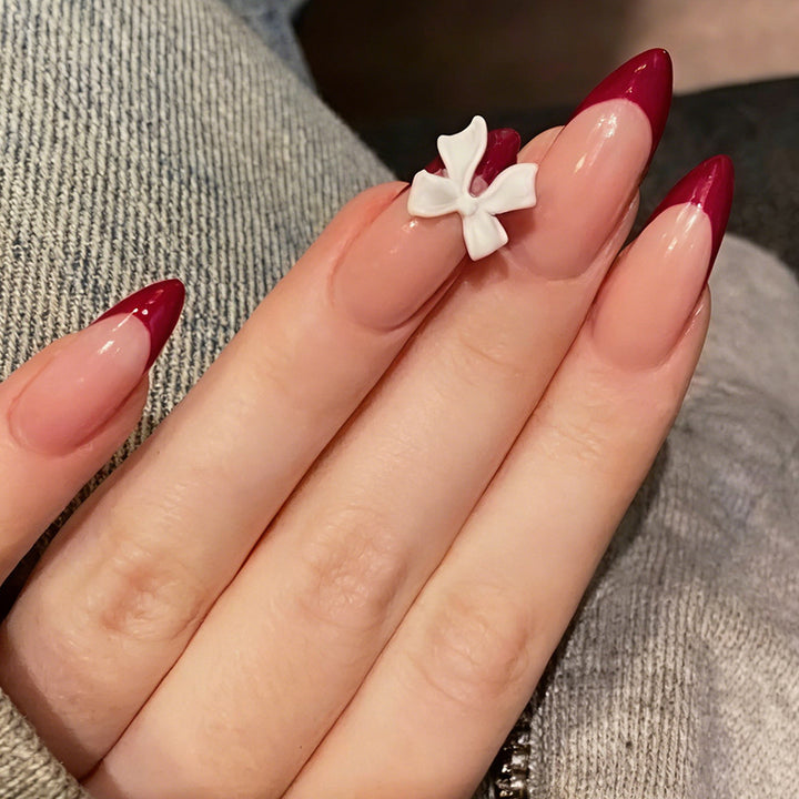 Acrylic nail set with creative French tip design and cute bows Stornfield