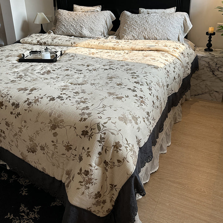 Quilted bedspread with lace trim and vintage stripe pattern