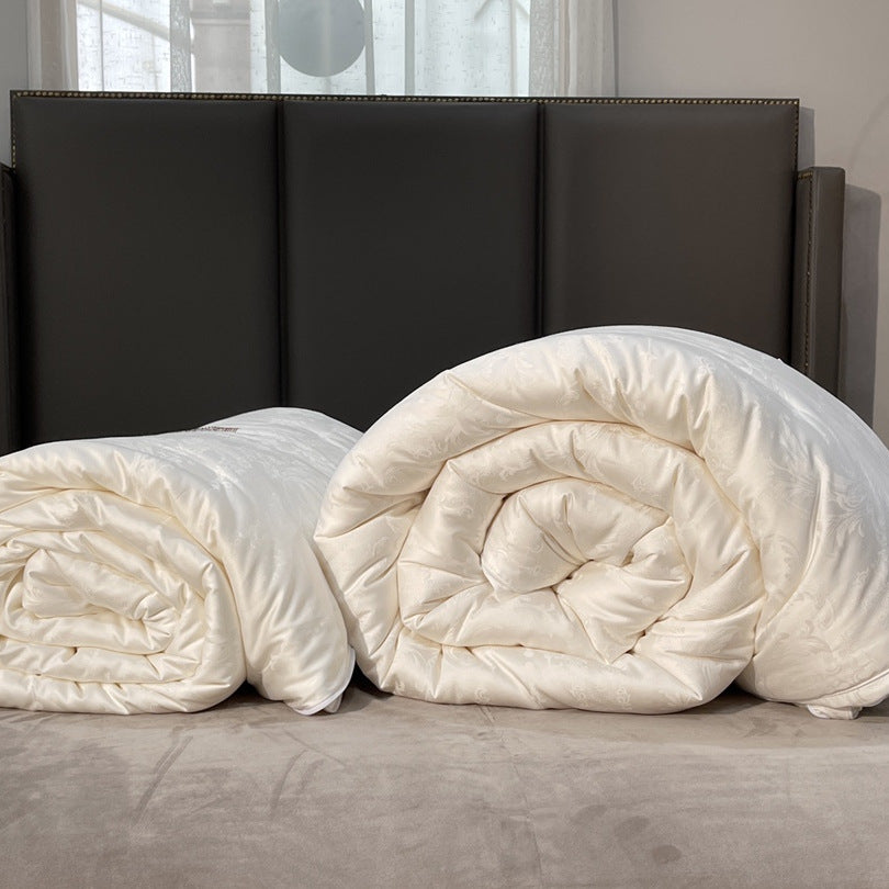 Quilted down look comforter with fine jacquard satin cover and crown embroidery