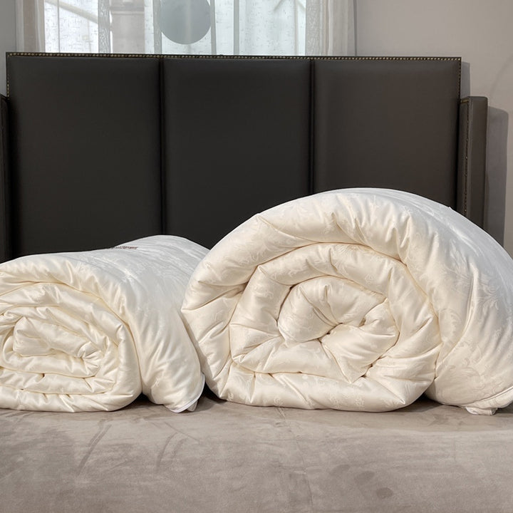 Quilted down look comforter with fine jacquard satin cover and crown embroidery