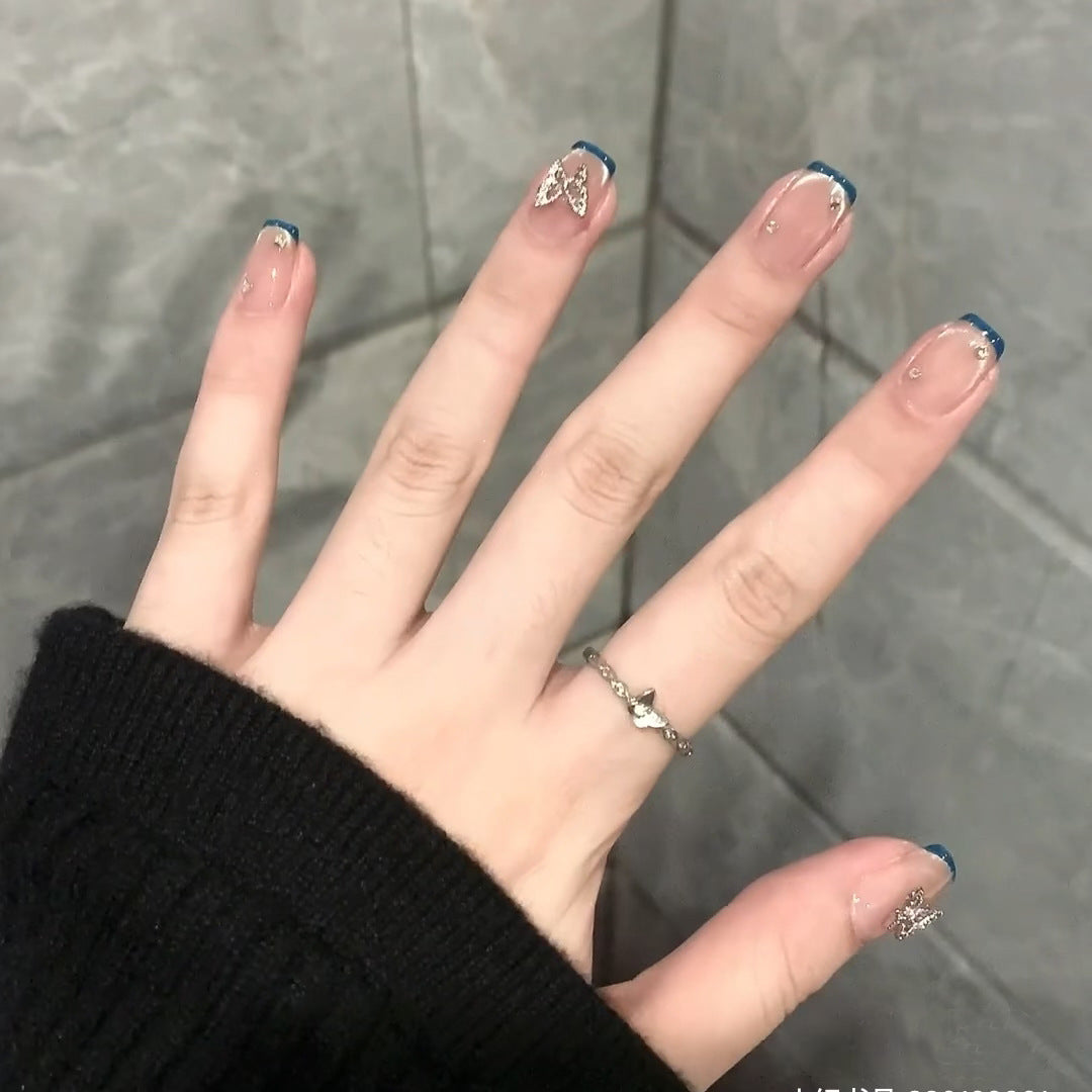 Artificial nails with trendy French tips and decorative glitter accents Stornfield