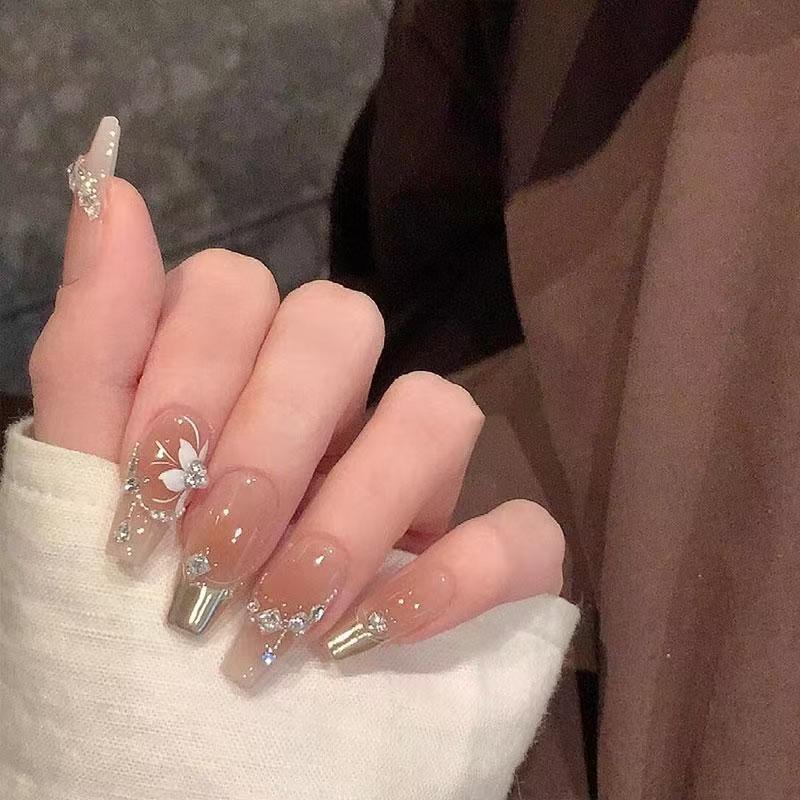 Elegant Press-On Nail Art with Floral and Gemstone Details Stornfield