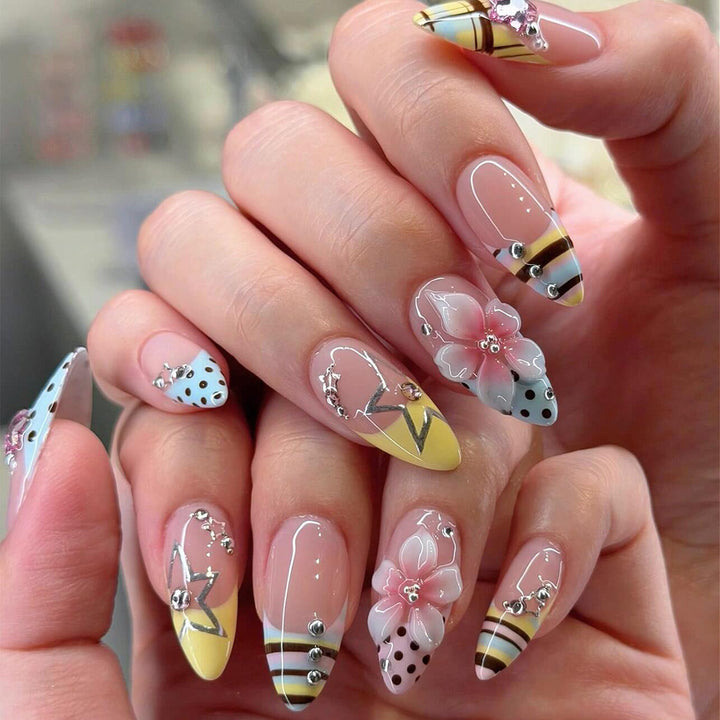 Creative nail designs with floral accents and glitter Stornfield