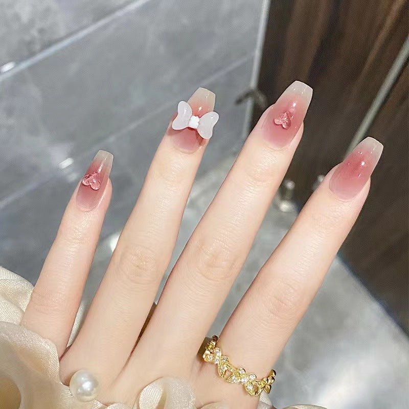 Artful acrylic nails with heart and bow design Stornfield