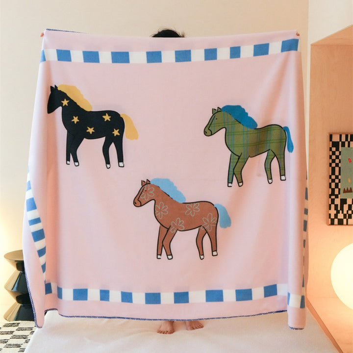 Children's cuddly blanket made of soft fleece with horse print and decorative edge