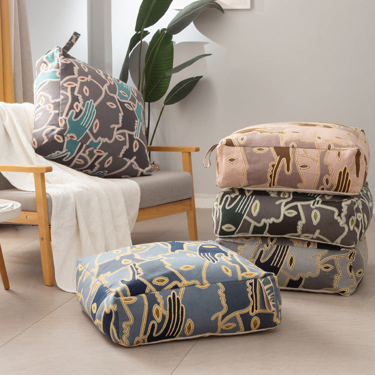 Square floor cushion cover with embroidered line pattern and carrying handle