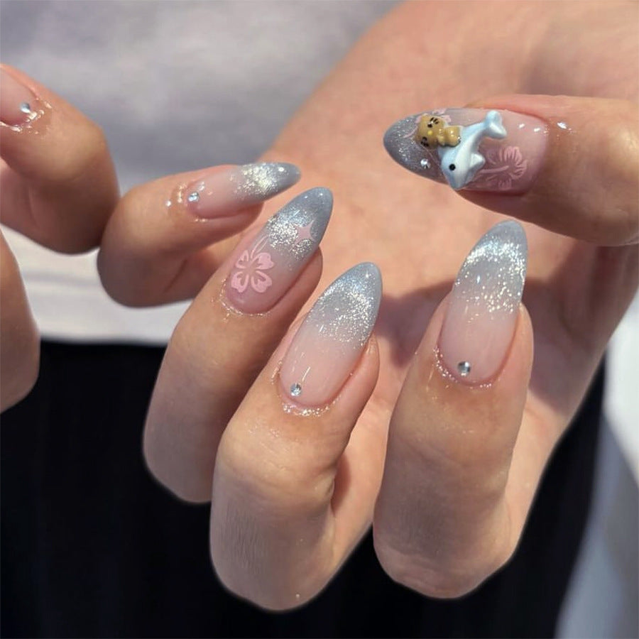 Artful nail extensions with elegant ombré design and floral accents Stornfield