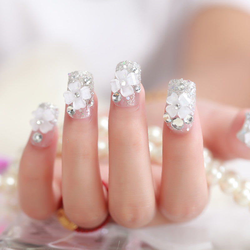 Artificial nails with glitter and floral 3D accents Stornfield