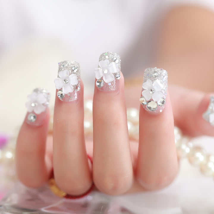 Artificial nails with glitter and floral 3D accents Stornfield