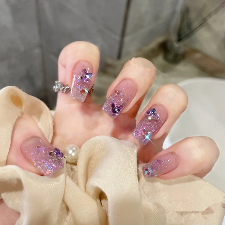 Glamorous artificial nails with glitter and floral accents Stornfield
