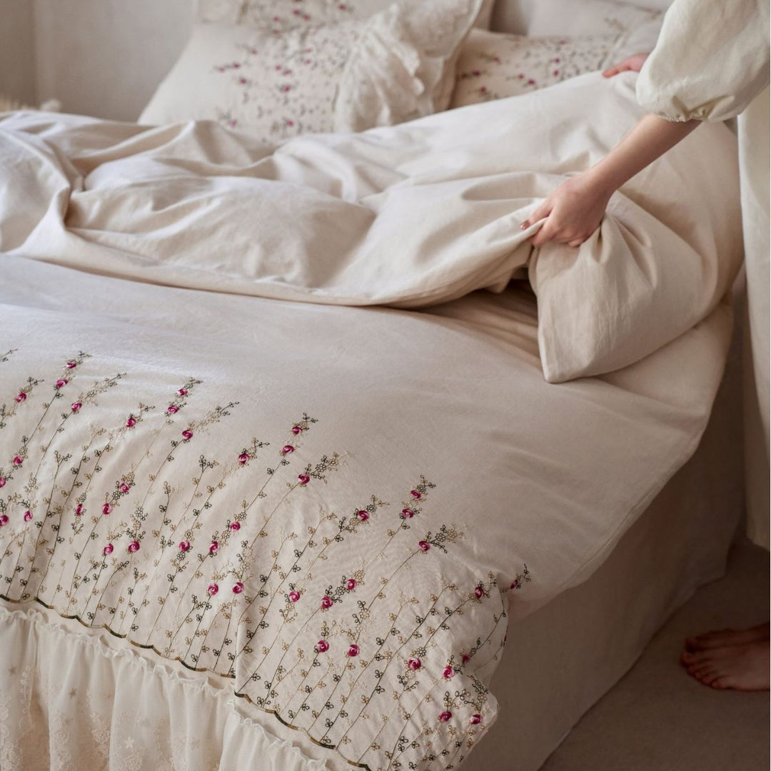 Vintage-inspired ruffled blanket and pillow set made of cotton muslin with delicate floral embroidery