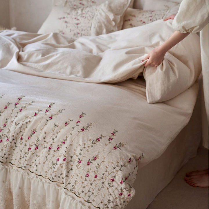 Vintage-inspired ruffled blanket and pillow set made of cotton muslin with delicate floral embroidery